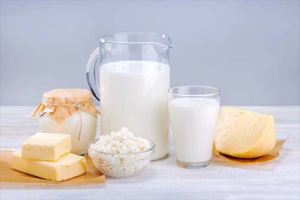 A glass of milk with a close-up of the label highlighting "Lactose" as a natural sugar component.