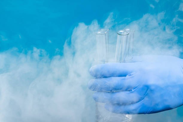 A laboratory scientist handling liquid nitrogen in a scientific lab.