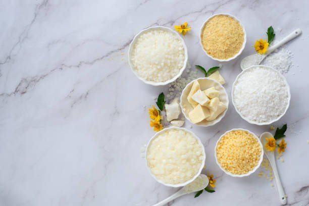 A bottle of liquid emulsifier being added to a mixture, demonstrating its role in blending oil and water.