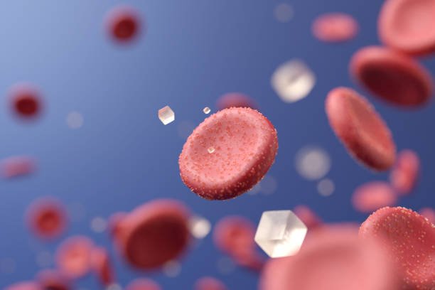 A glass of glucose solution in a medical setting, with a glucose tablet beside it.