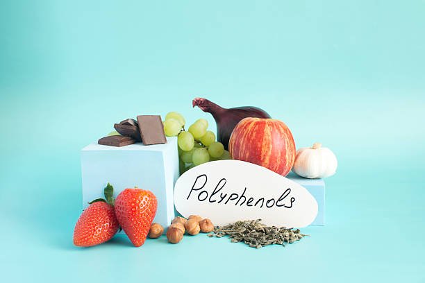A colorful assortment of fruits, vegetables, tea, and spices rich in polyphenols, showcasing their natural sources.