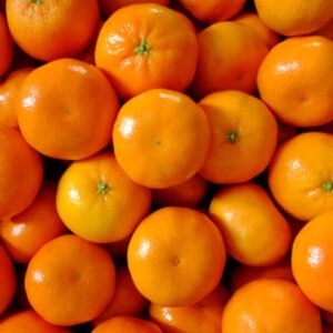 Fresh orange fruit with vibrant orange peel and juicy segments, rich in vitamin C.